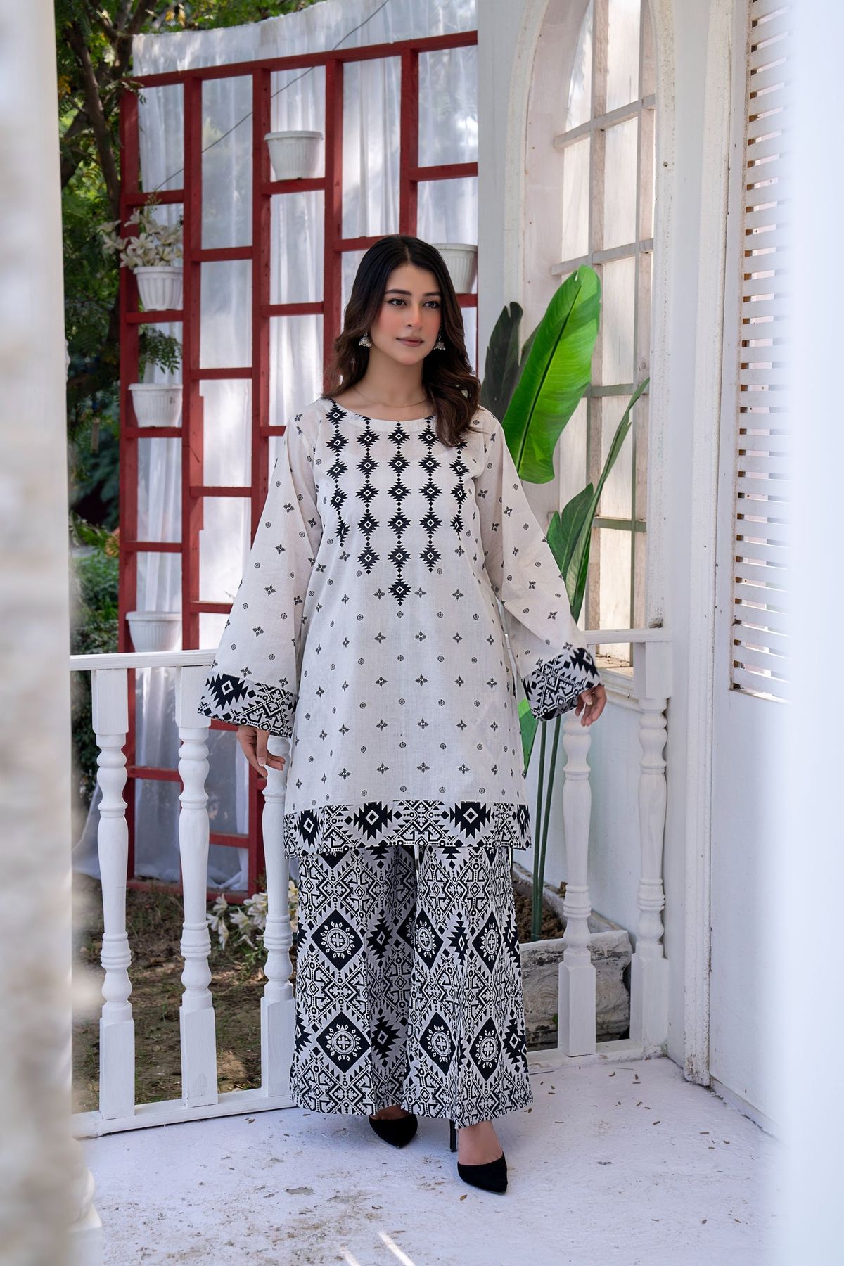 White lawn suit with black geometric embroidery at the neckline and cuff