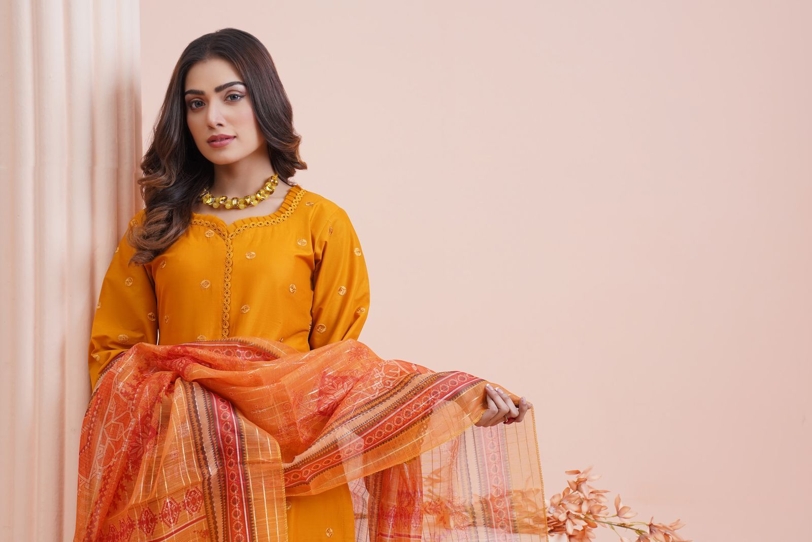 Mustard Pakistani ladies suit with a printed dupatta